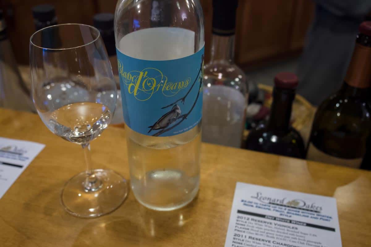 blanc d'orleans bottle of wine with glass at wine tasting from leonard oakes winery