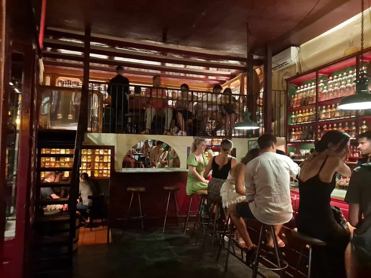 people sitting at bar and tables at upper level of dr. stravinsky