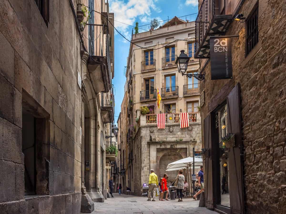 pedestrians walking the streets of the historic gothic old town