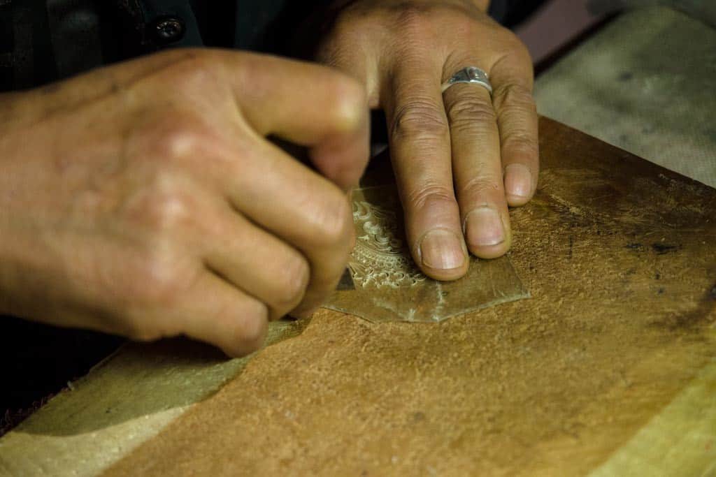 Local craftsman delicately cutting through leather to create those shadow puppets we saw in Xi'an.