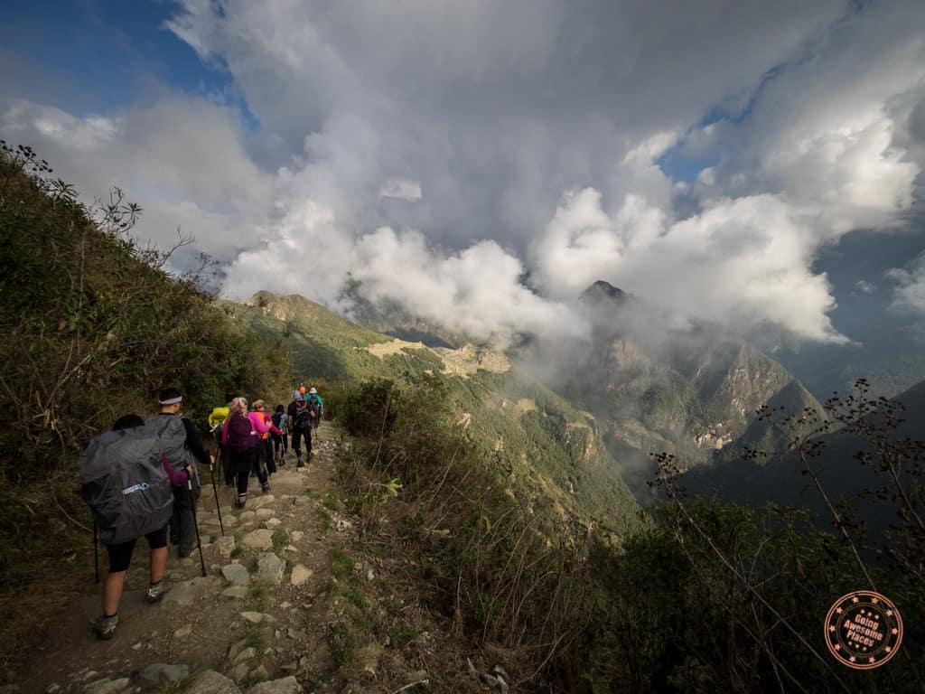 ruins of machu pucchu appearing as clouds lift along the inca trail in peru