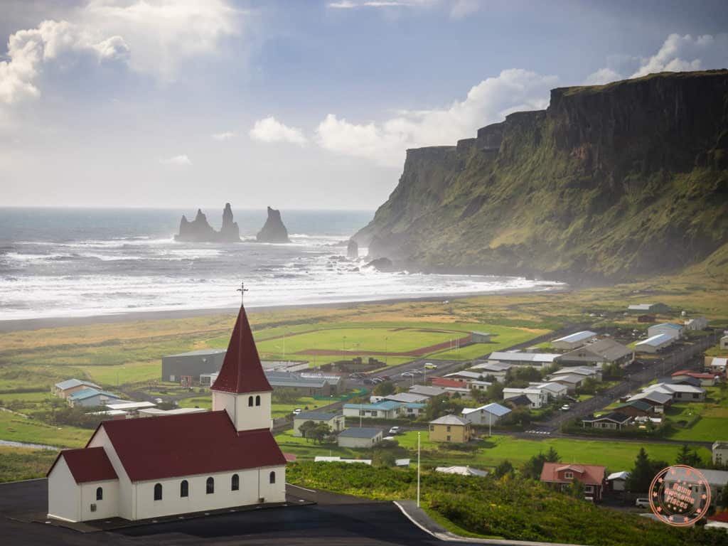 vik red church and view of reynisdrangar in the distance