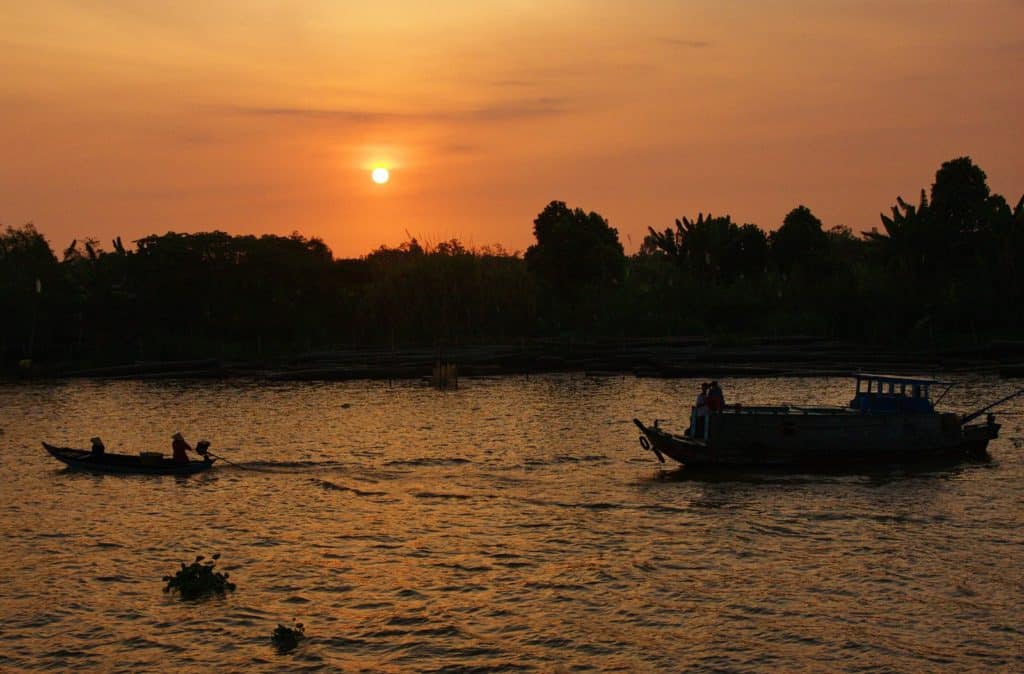 meking delta at sunset with boats