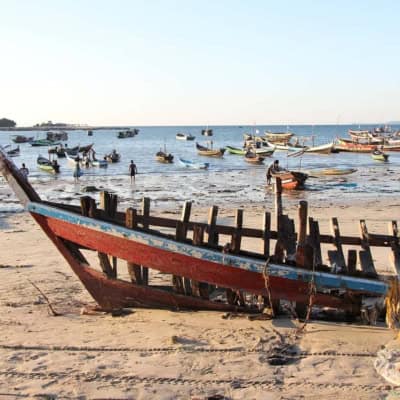 myanmar beach with a traditional boat