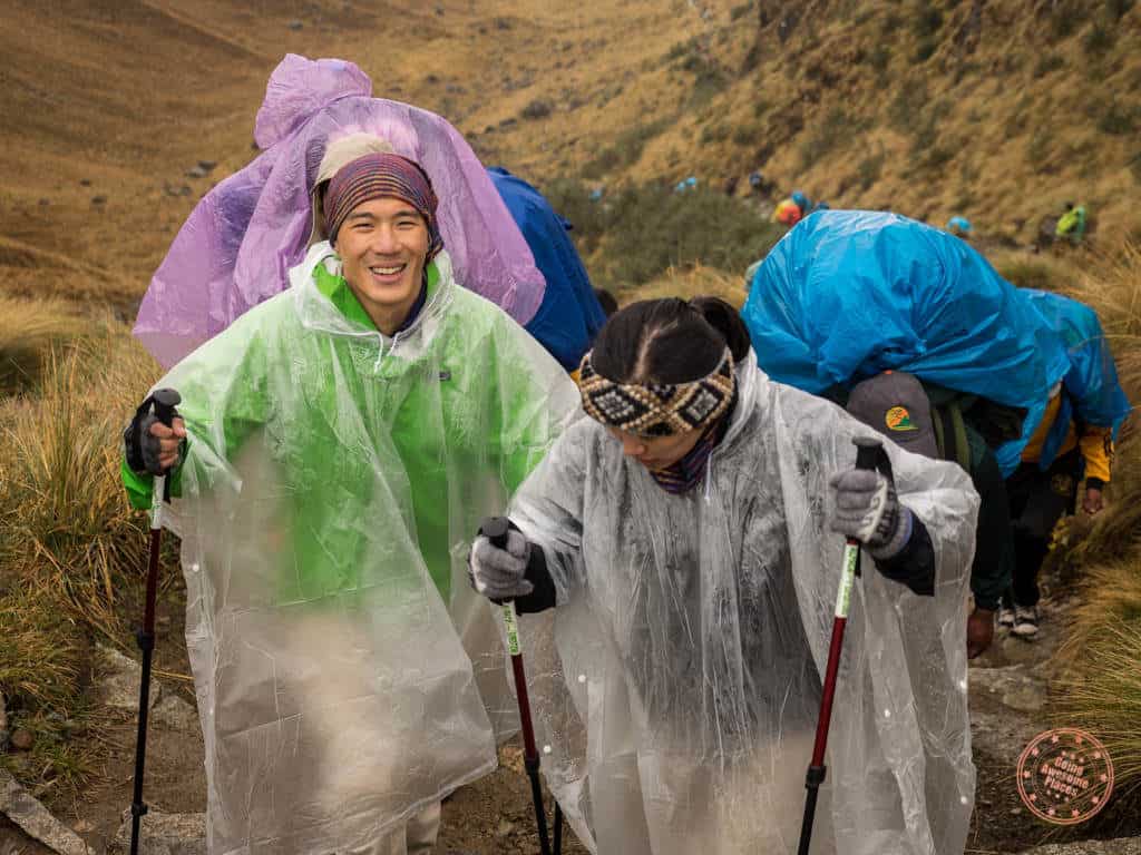 hiking up deadwoman's pass with rain jacket and poncho