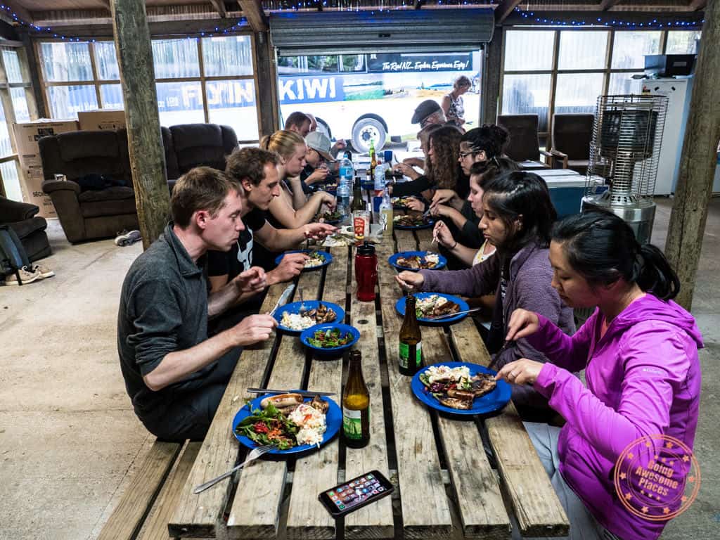 eating communal dinner with flying kiwi travel mates nz