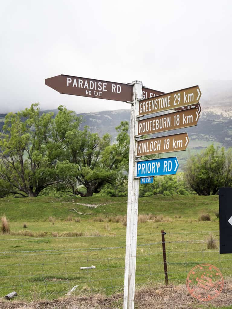road sign for paradise road in new zealand itinerary