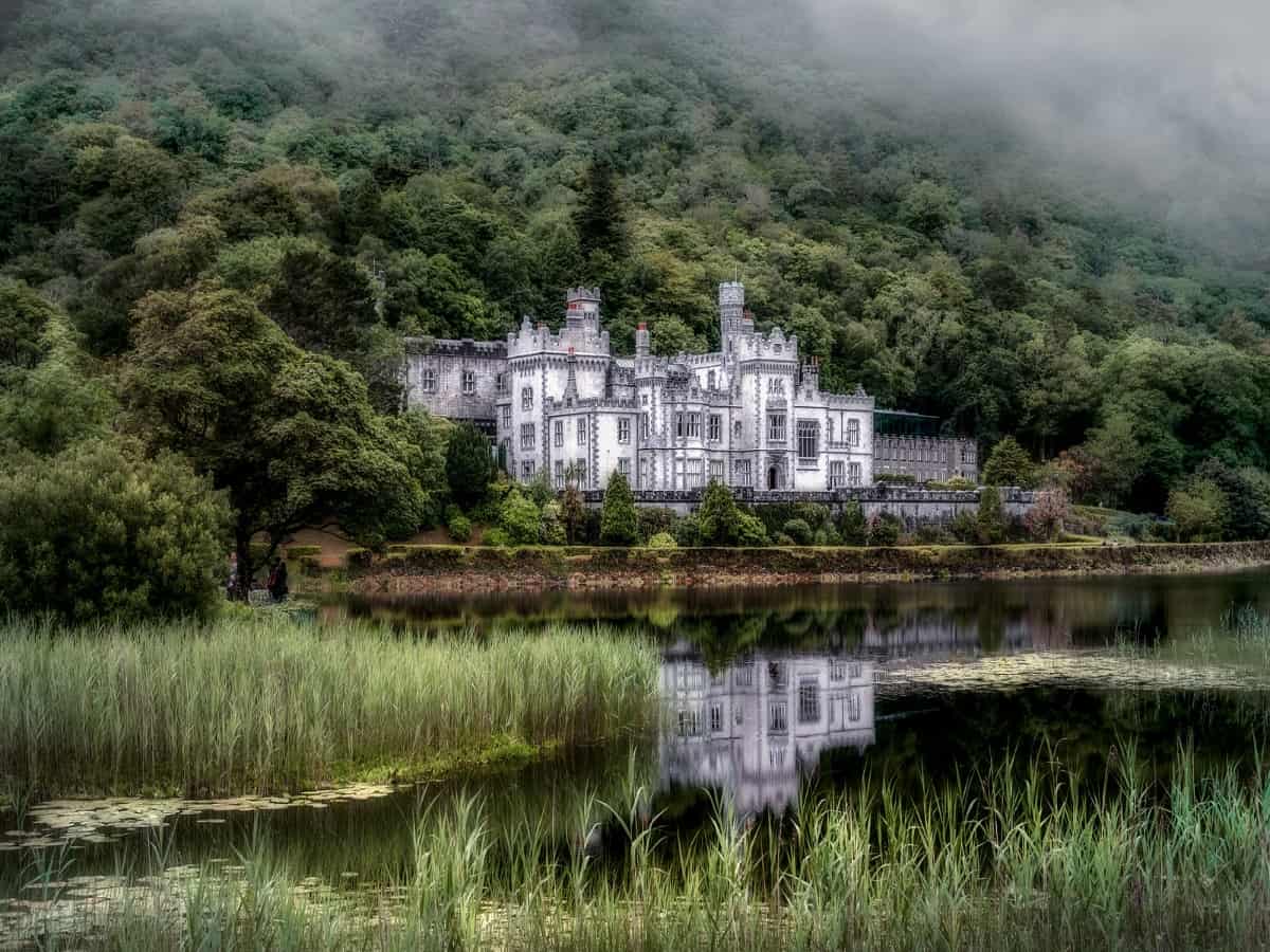 distant view of kylemore abbey on other side of lake