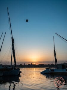 luxor at sunrise with hot air balloon and nile