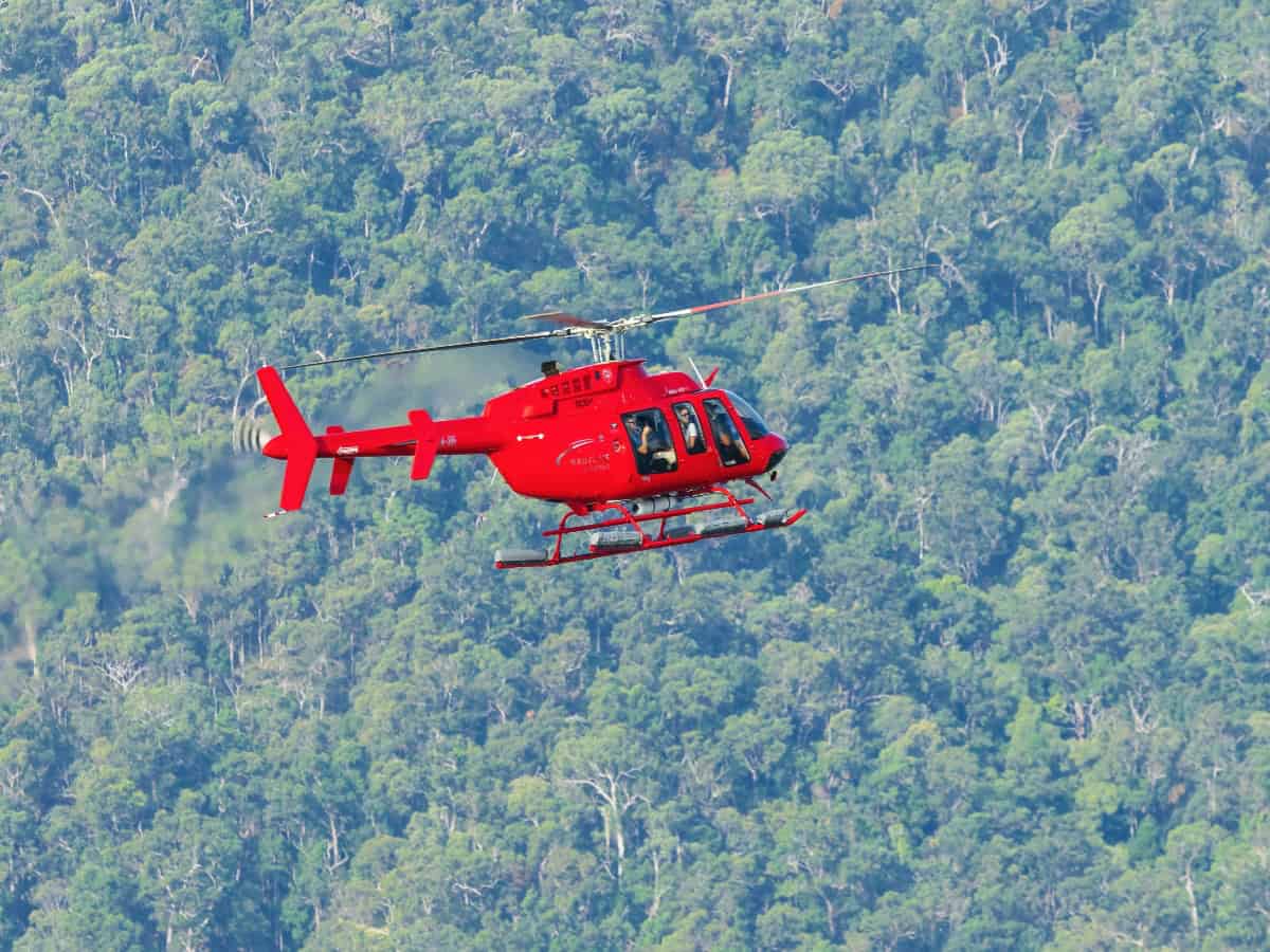 red tour helicopter over cairns