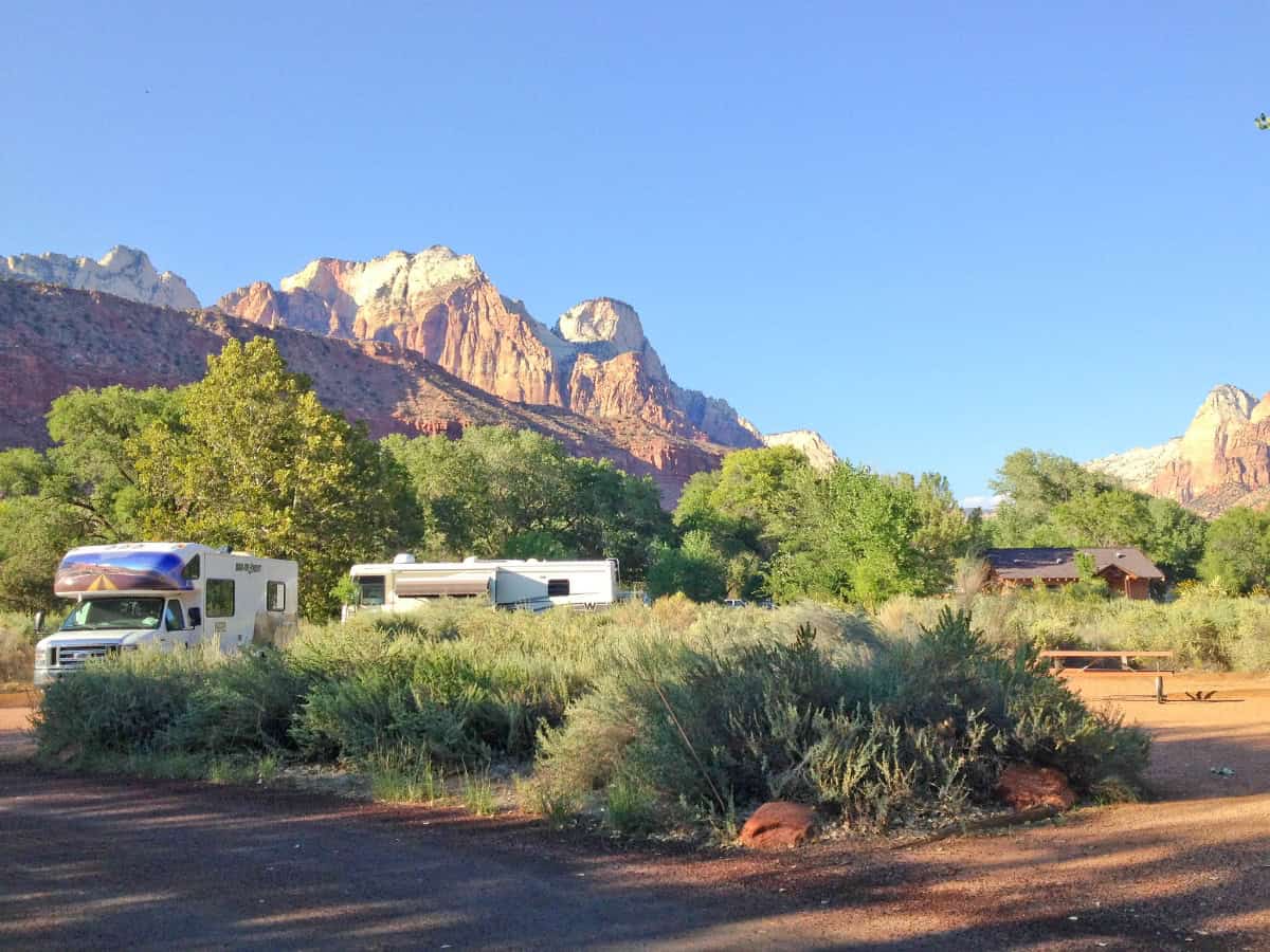 rv's parked in front of cliffs in zion national park