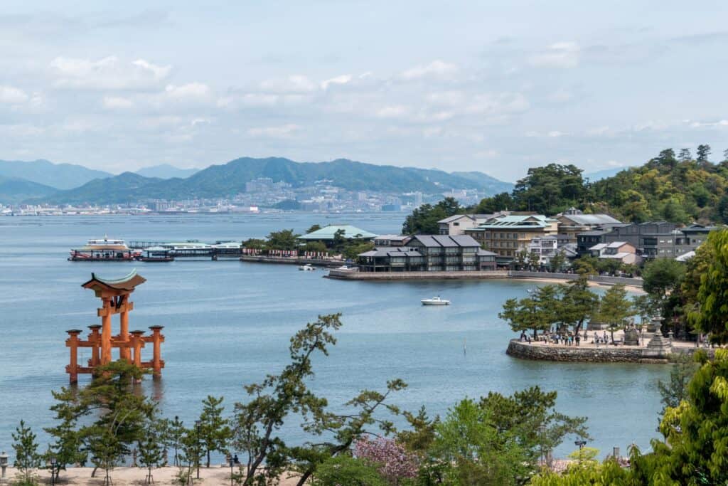 ocean view of Hiroshima city with mountains and houses in the distance.