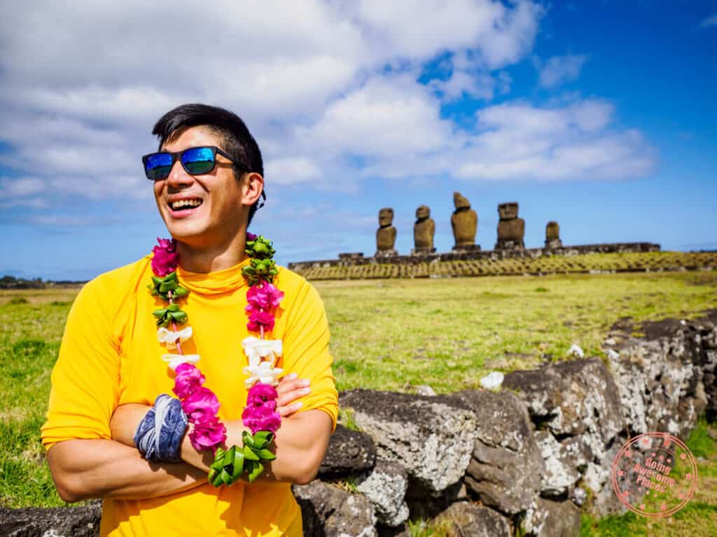 man smiling while posing in tahai easter island with a lei