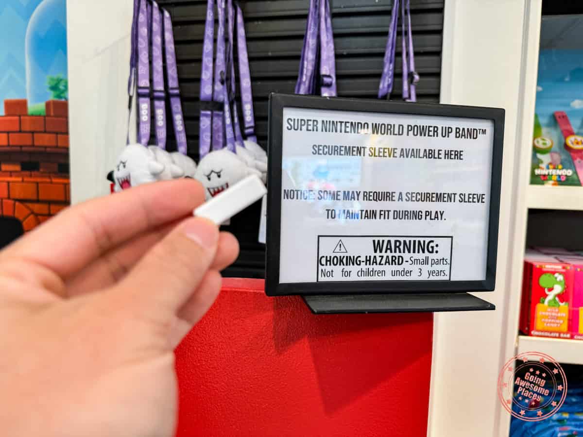 super nintendo world power up band securement sleeve availability sign at character shop of universal studios