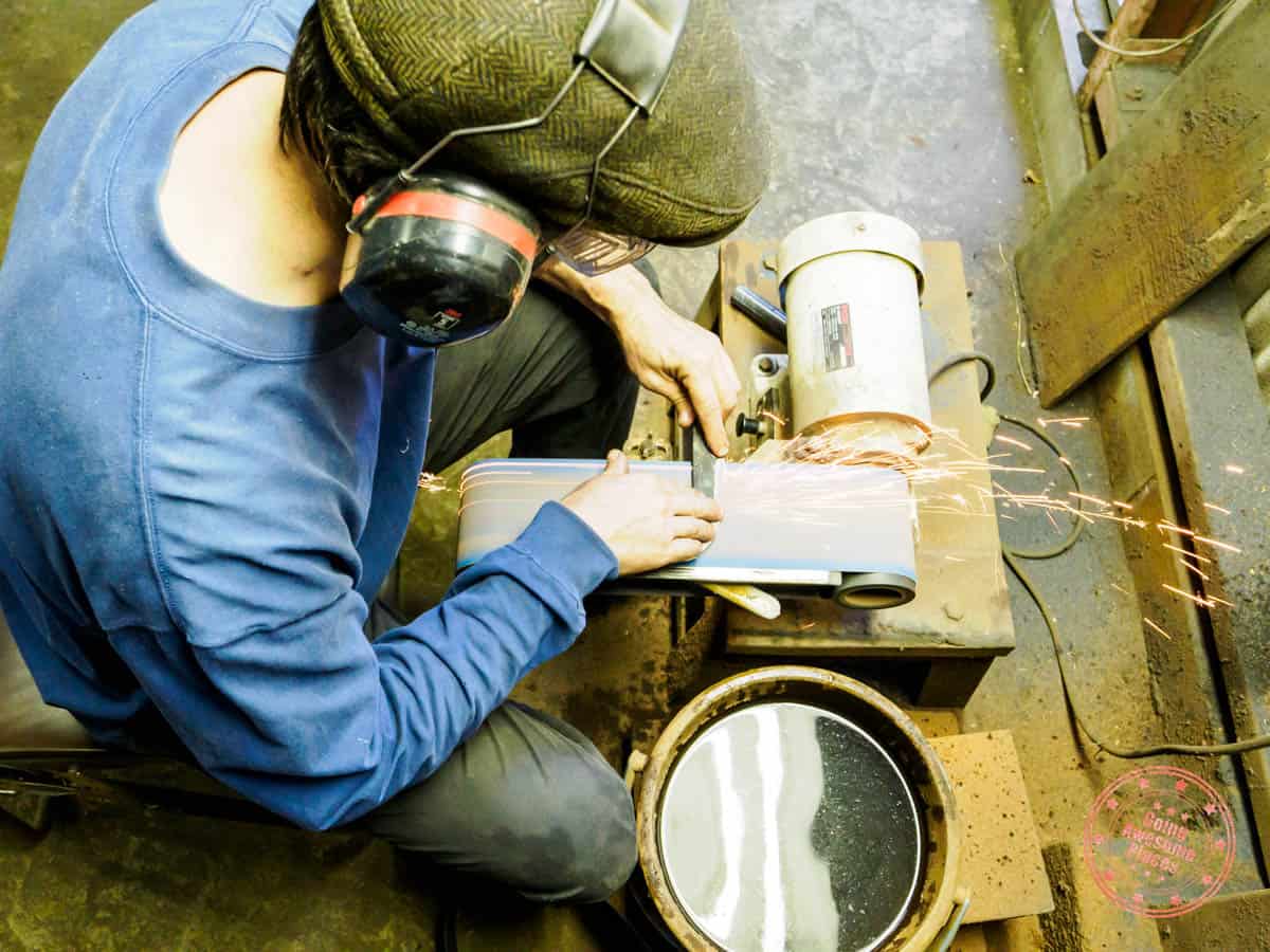 apprentice jesse in sanding station during kurogane knife making workshop