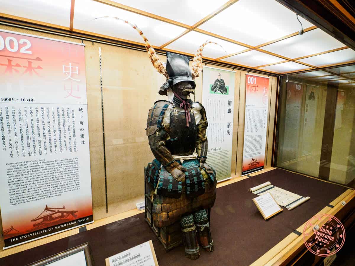 samurai armor on display inside matsuyama castle main tower