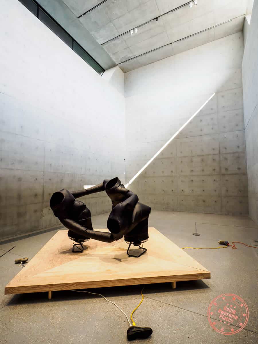 m plus contemporary artwork with three people tied together and blowing around