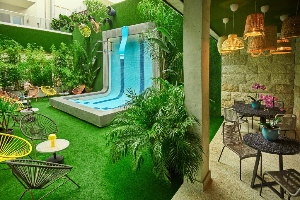 chic & basic gravity hotel garden area with large waterfall fountain