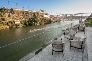 eurostars porto douro terrace seating overlooking bridge and boat on river