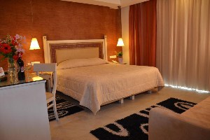 best places to stay in corfu odysseus hotel room with king bed and vanity