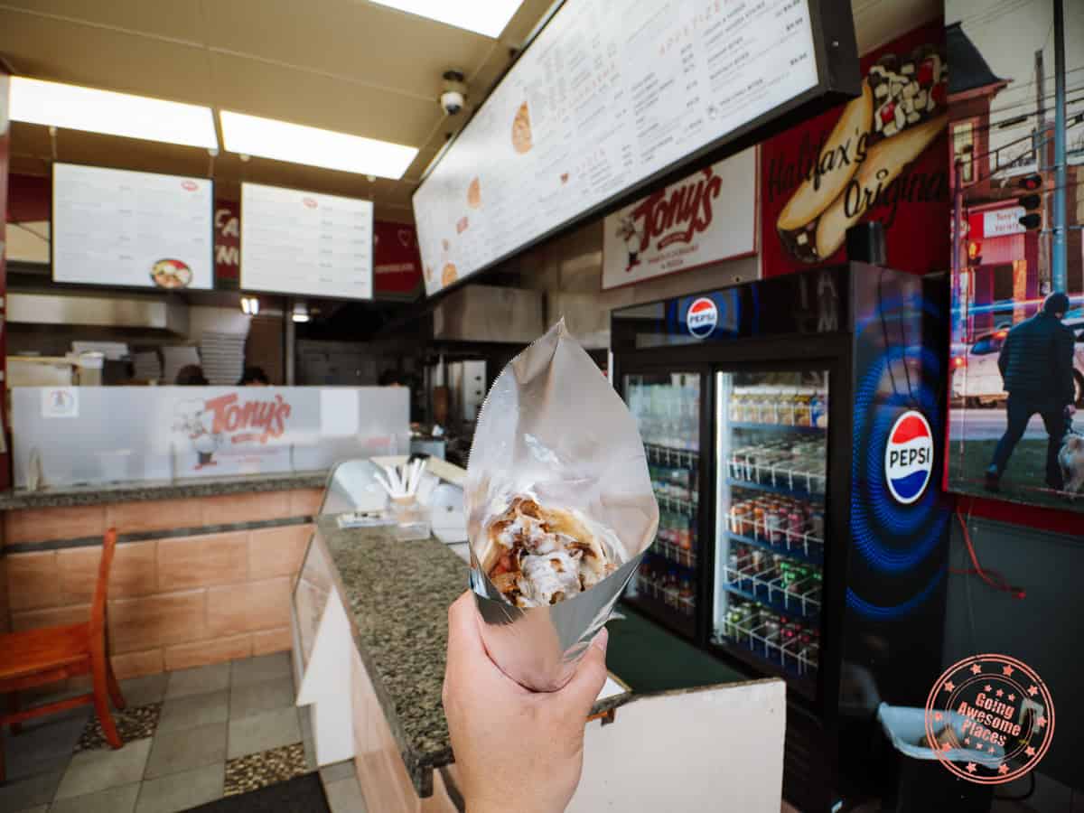 holding a donair at tony's world famous donairs in halifax
