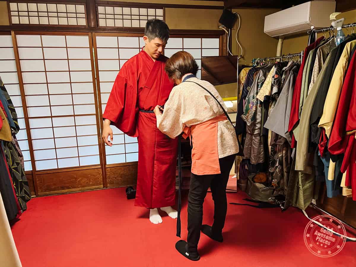 10 Day Japan Itinerary For First Timers - Modern Golden Route man getting dressed in a kimono in kyoto