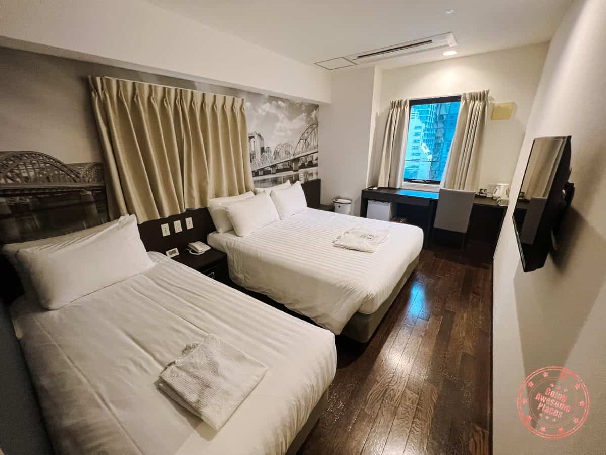 10 Day Japan Itinerary For First Timers - Modern Golden Route interior bedroom of travelodge honmachi osakak hotel with triple occupancy set up