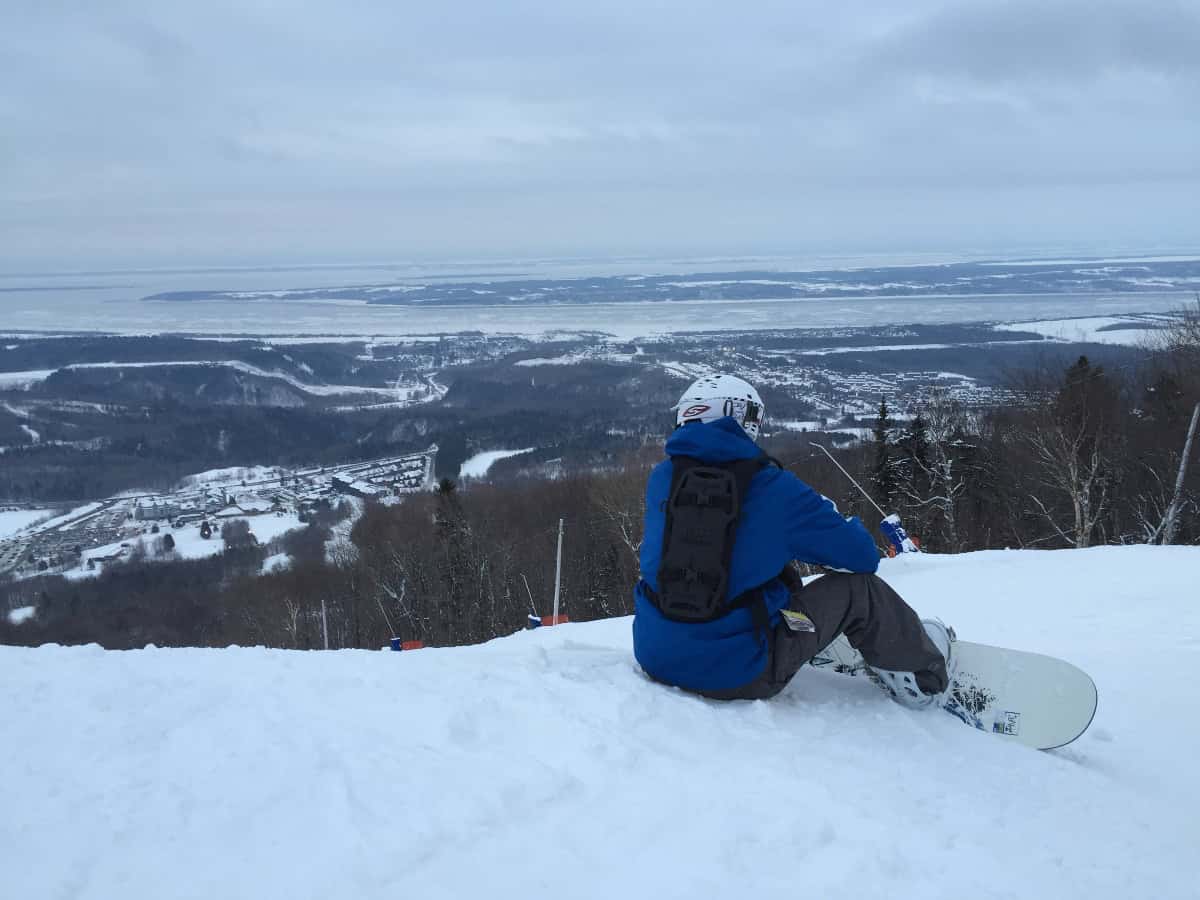 taking a break from snowboarding to overlook the slopes