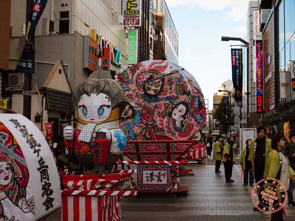 floats in a parade in the busy streets of tokyo