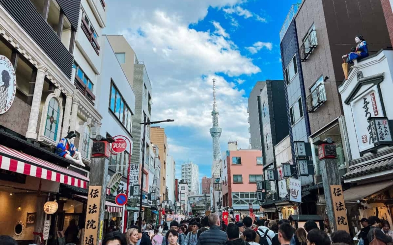 skytree in the background of a busy tokyo street