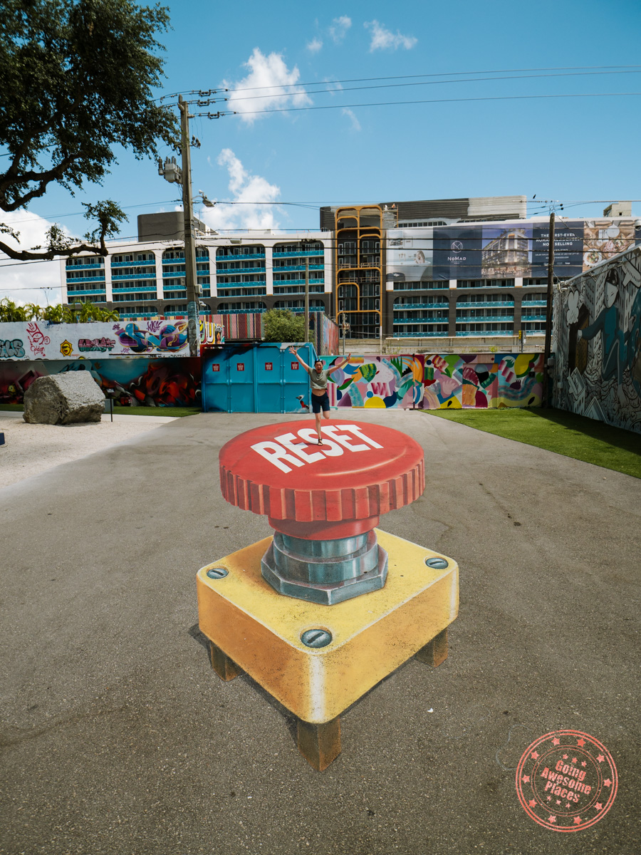 chantelle jumping on reset button street art at wynwood walls miami