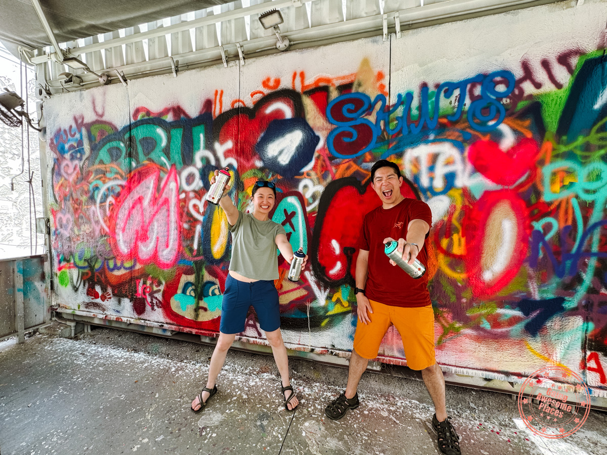 couple in wynwood walls spray freestyle with miami street art