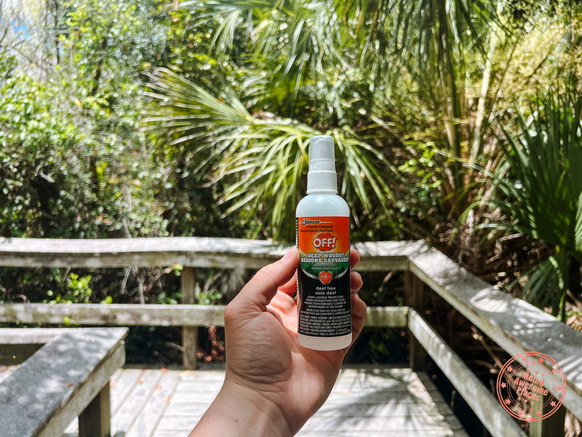 holding off mosquito repellent in hike trail of everglades national park