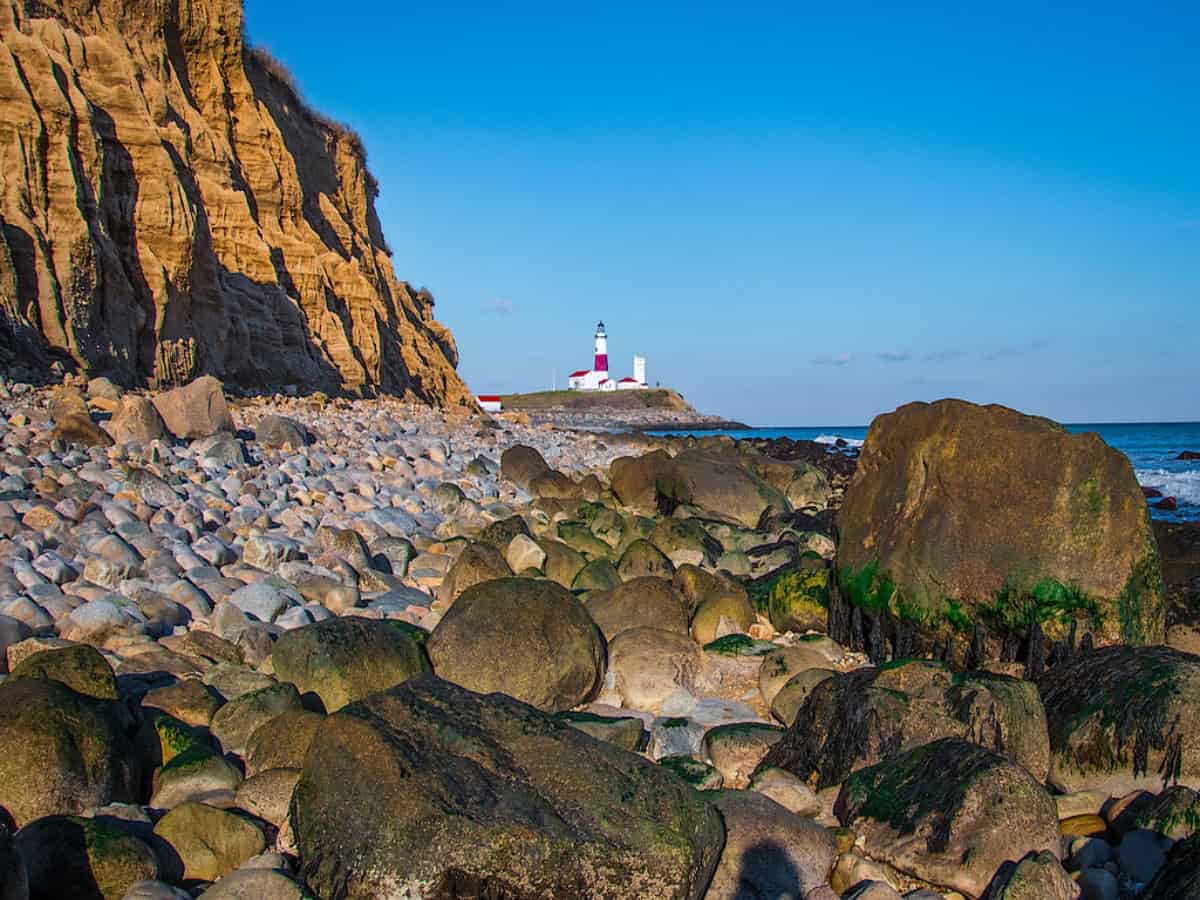 hoodoos on the coast with view of lighthouse from camp hero state park