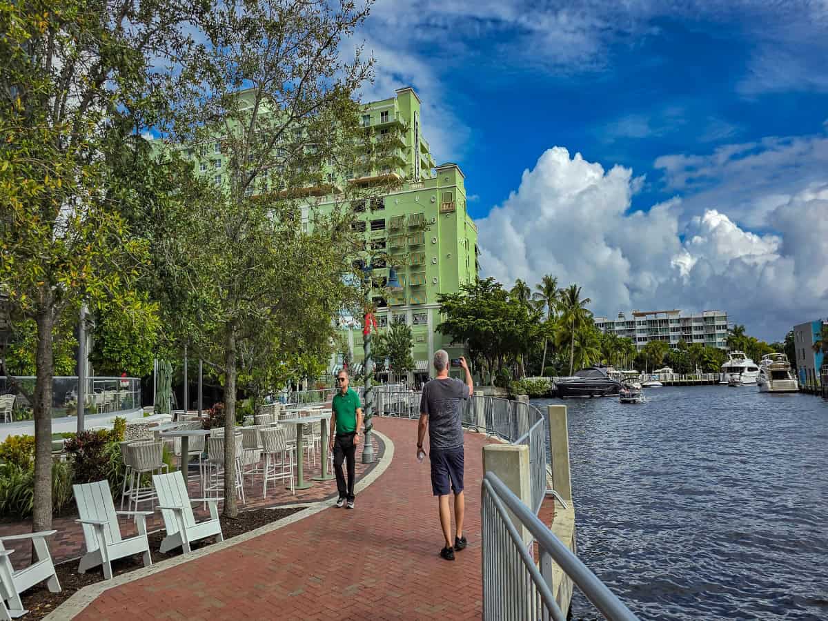 people walking along fort lauderdale’s riverwalk along new river
