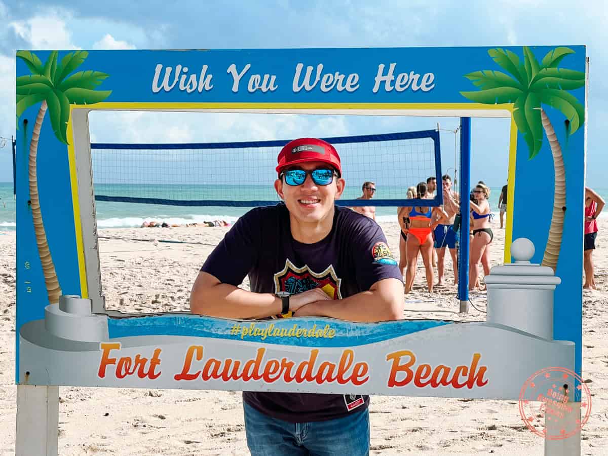 taking photo by sign on ft lauderdale beach
